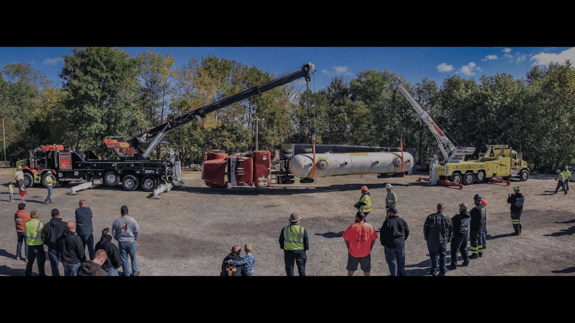 two NRC CSR wreckers team lifting and overturned tanker truck during a towing demo.