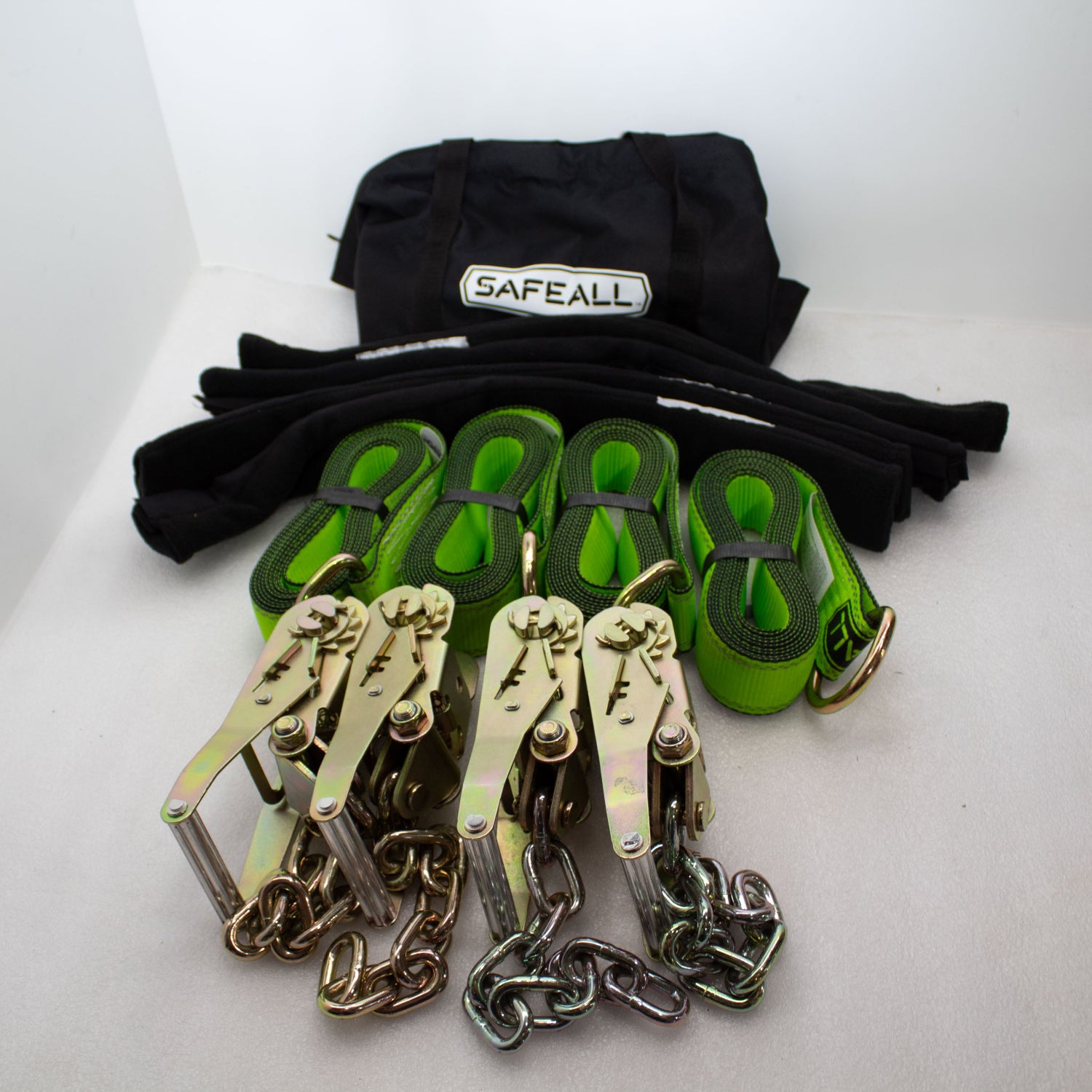 A set of SafeAll 4 Point Soft Tie-Downs with D-Rings, featuring four durable black straps with metal D-ring connectors, neatly coiled and arranged against a white background, designed for secure vehicle recovery and load securement in towing applications.