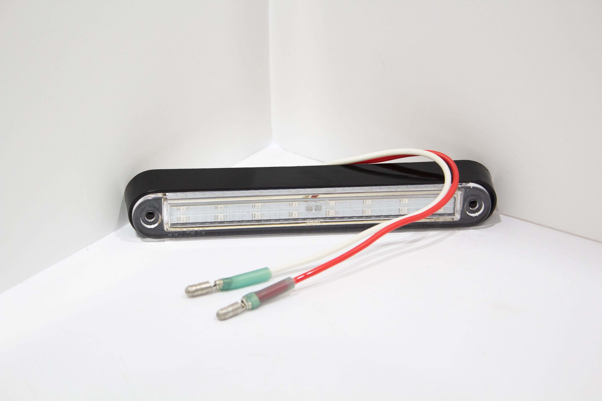 Amber LED position marker light with black bezel and connector wires for wrecker body clearance.