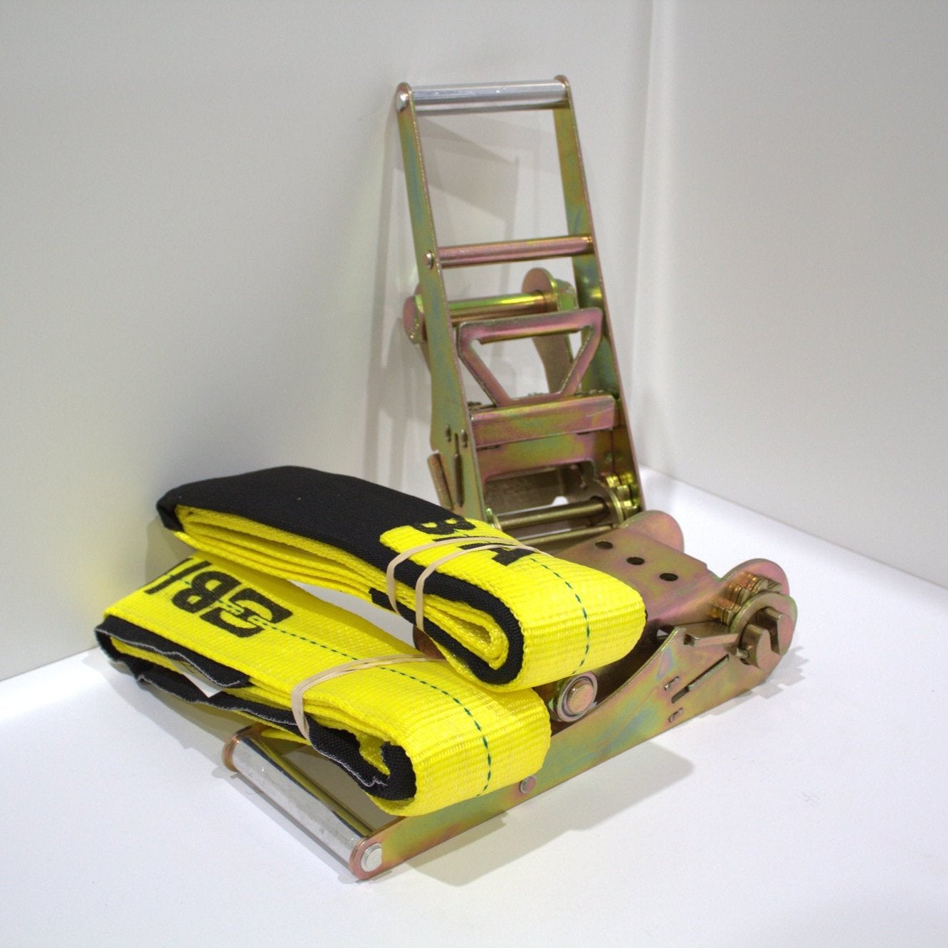 tie-down assembly with long handle ratchet and protective sleeve