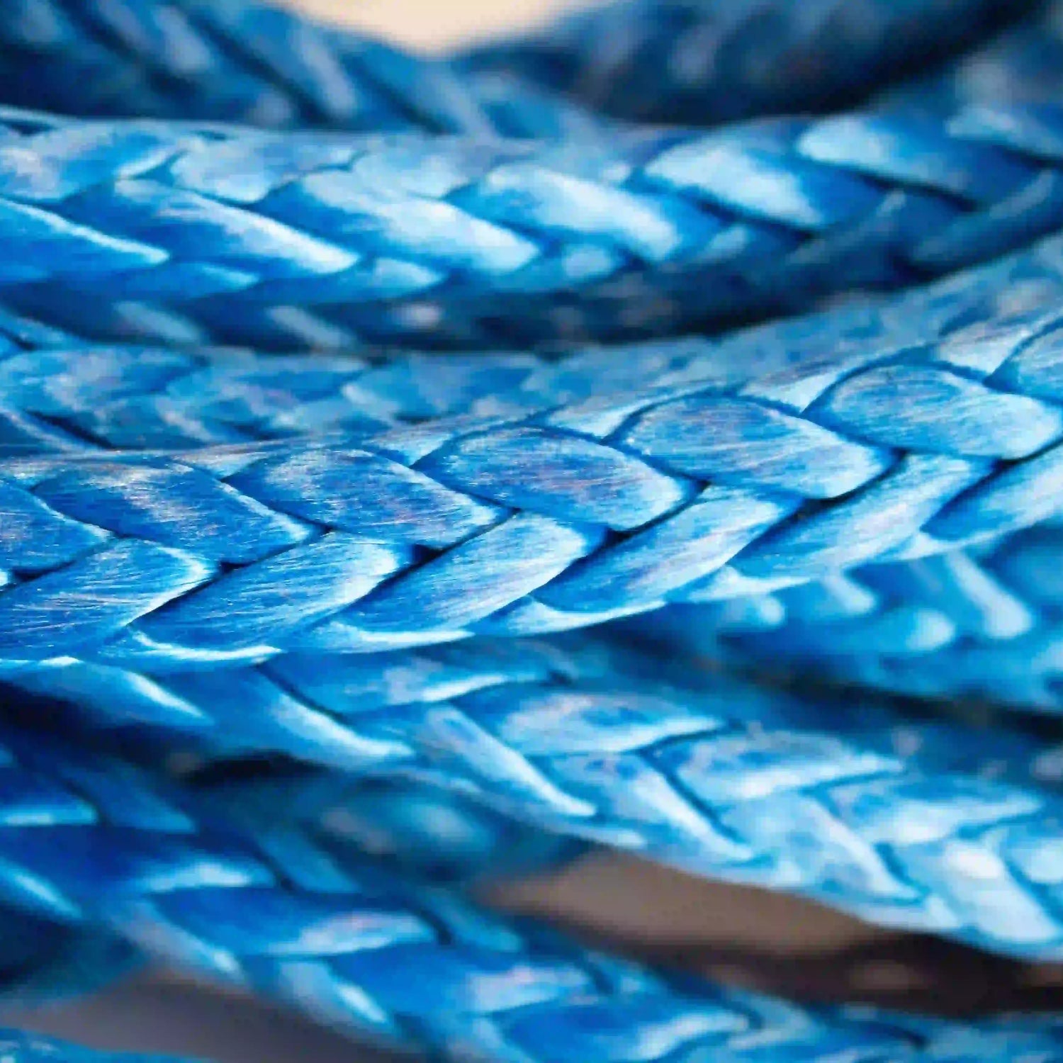 a close up of the self locking hook on a 3/8" x 75' synthetic winch line. Highlights the braided pattern that makes up the rope. 