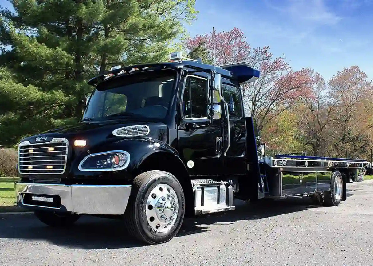 Black NRC car carrier tow truck with a flatbed design, highlighting heavy-duty performance, perfect for buyers searching for tow trucks for sale, flatbed trucks for sale, or heavy-duty wreckers for sale.