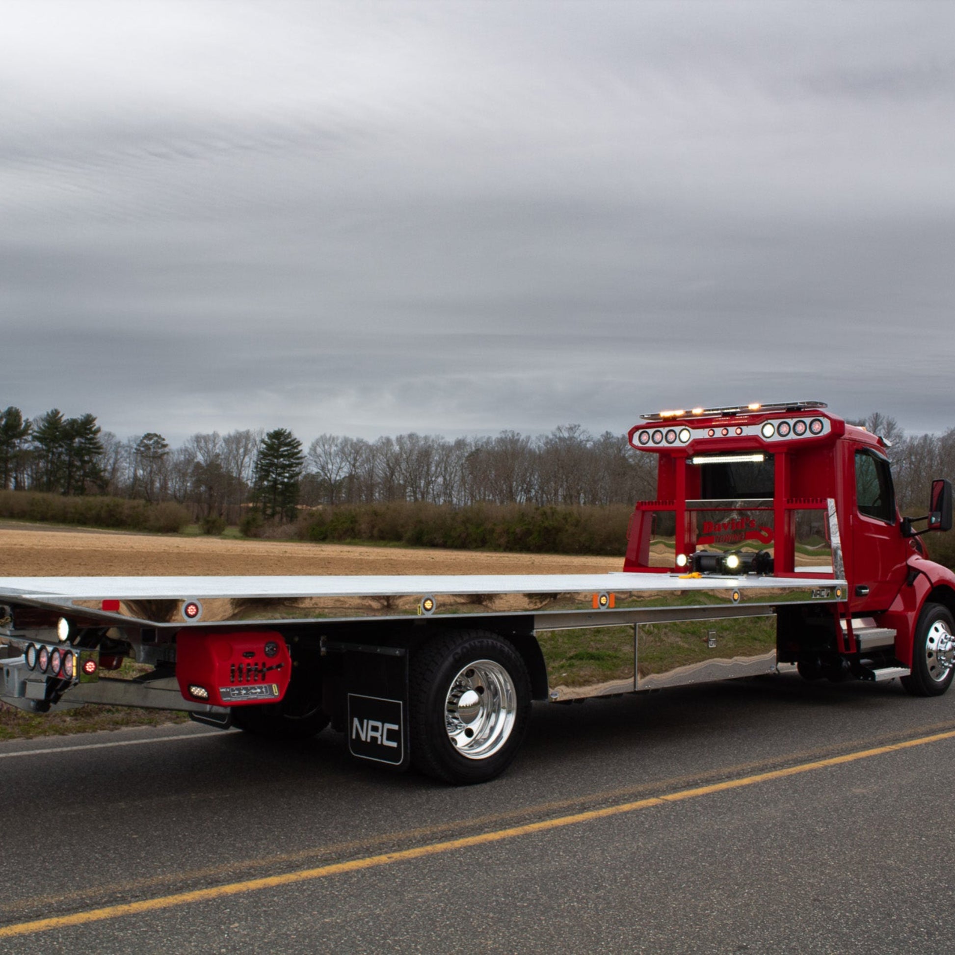 stainless trim kit for the side of the bed on a red tow truck