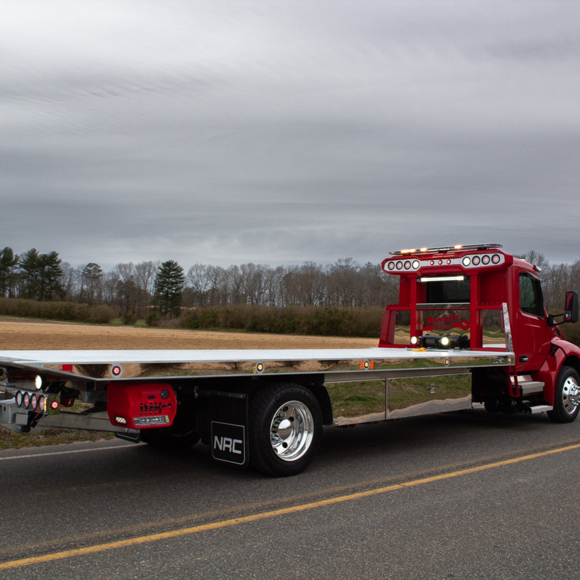 stainless trim kit for the side of the bed on a red tow truck