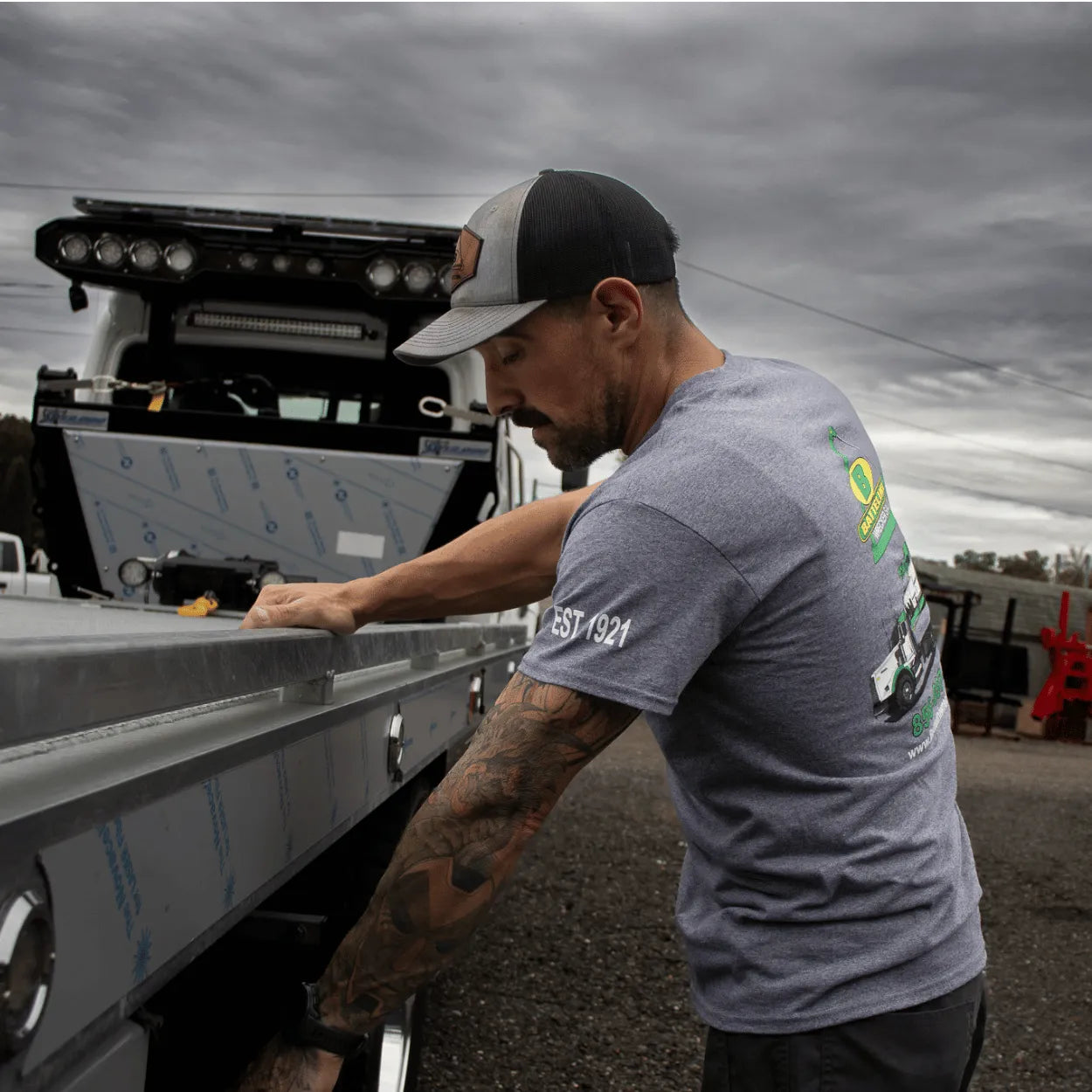 checking underbody toolboxes wearing battelini's graphite heather trucking t-shirt