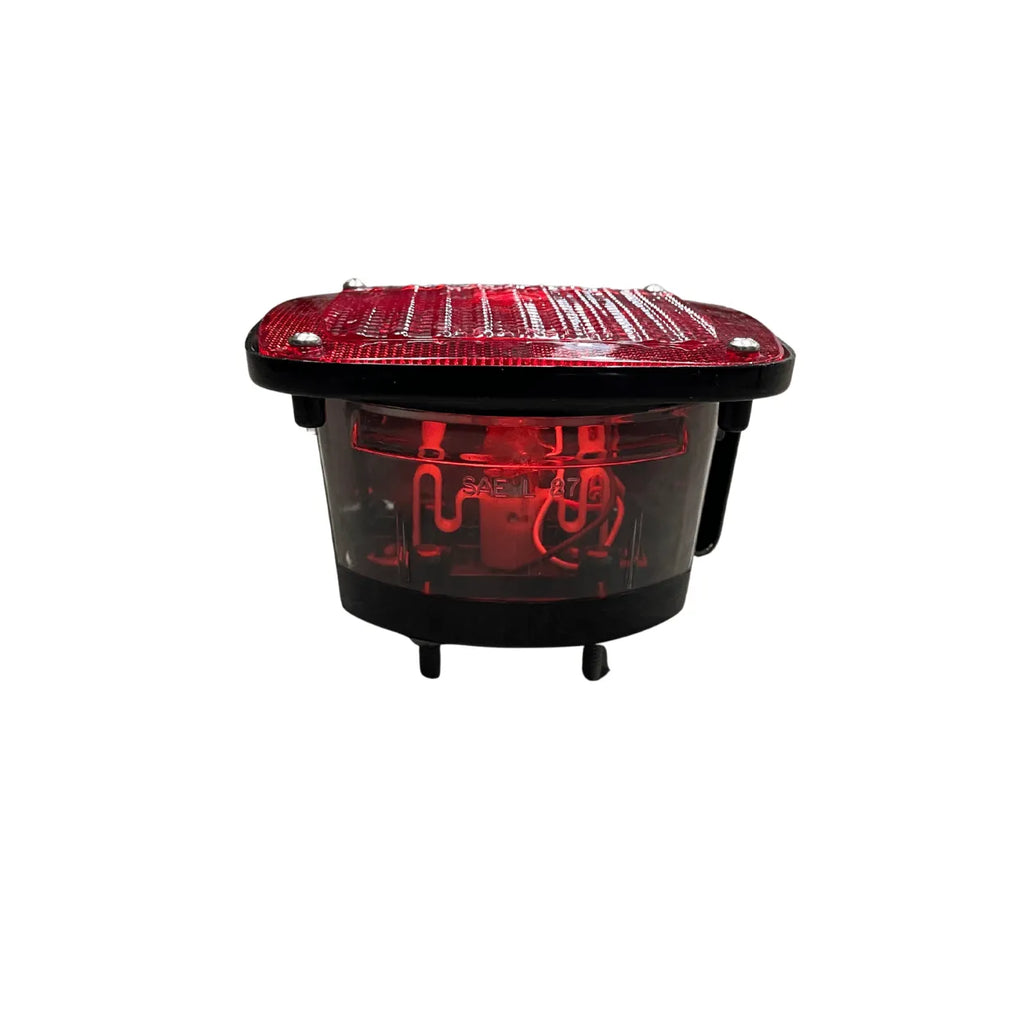 front view of Grote 01537176 combination tail light, red lens with clear back-up window on black box housing