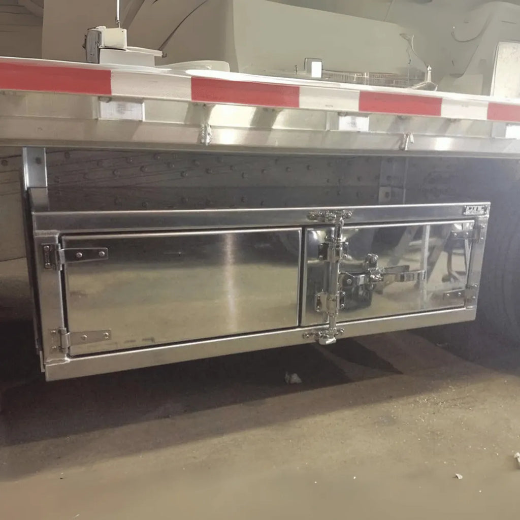 Premium underbody toolbox with a polished finish and camlock system, ideal for rollback tow trucks and trailers. Secure and sleek storage.