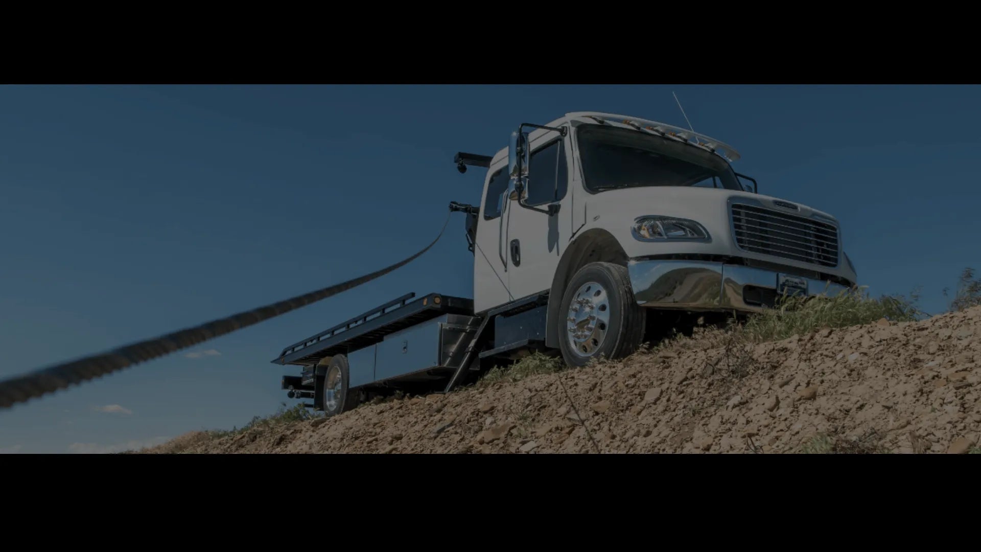 in the ditch sidepuller with winch lines out recovering a vehicle 
