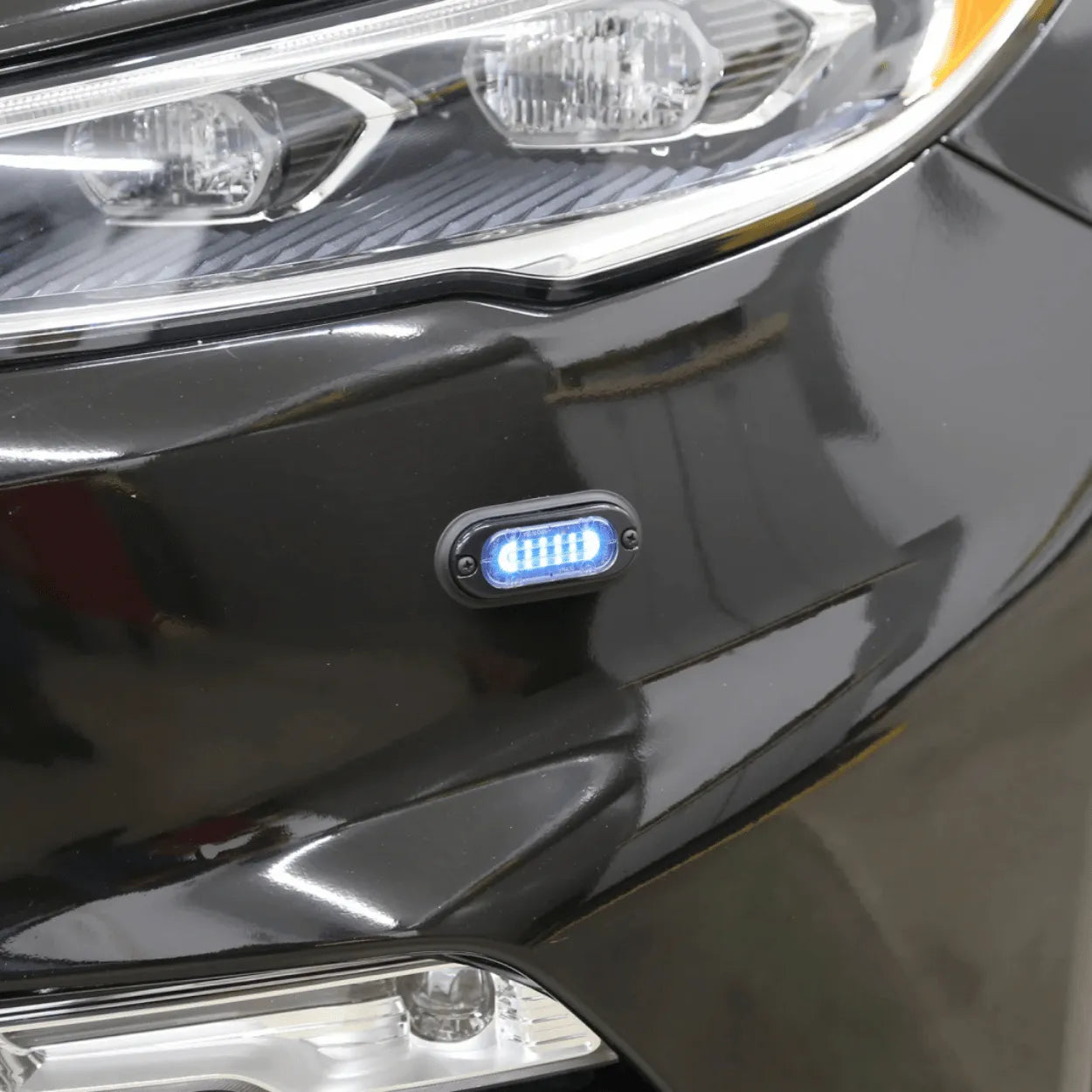whelen mini ion led lighthead installed on the front bumber of a vehicle