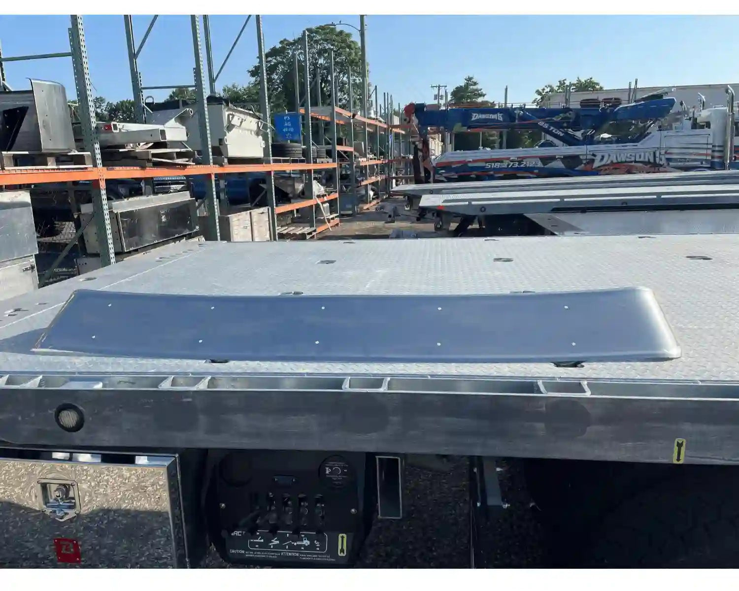 Exterior Stainless Steel Sun Visor C604  sitting on the bed of a car carrier - 22-64880-000