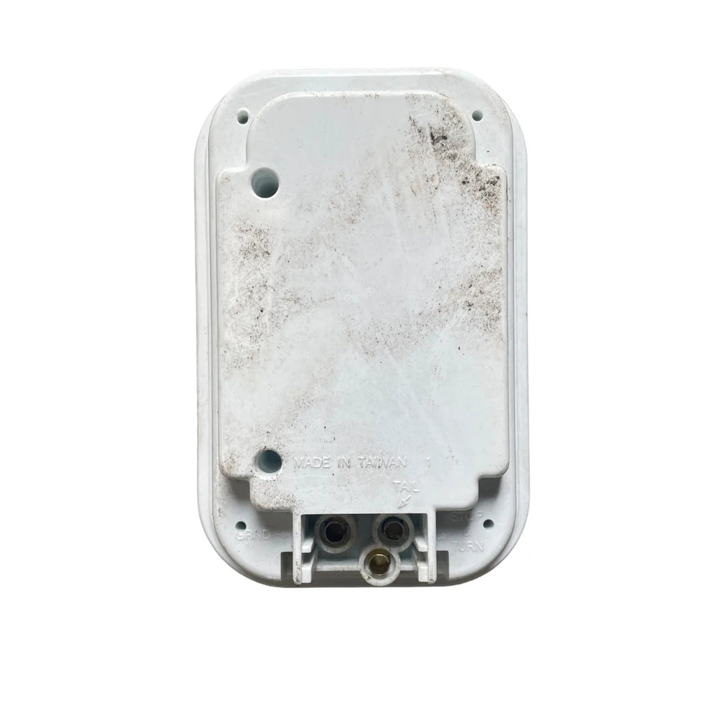 Optronics BU33CRXLBP back-up light rear view showing sealed polycarbonate housing and PL-3 plug terminals
