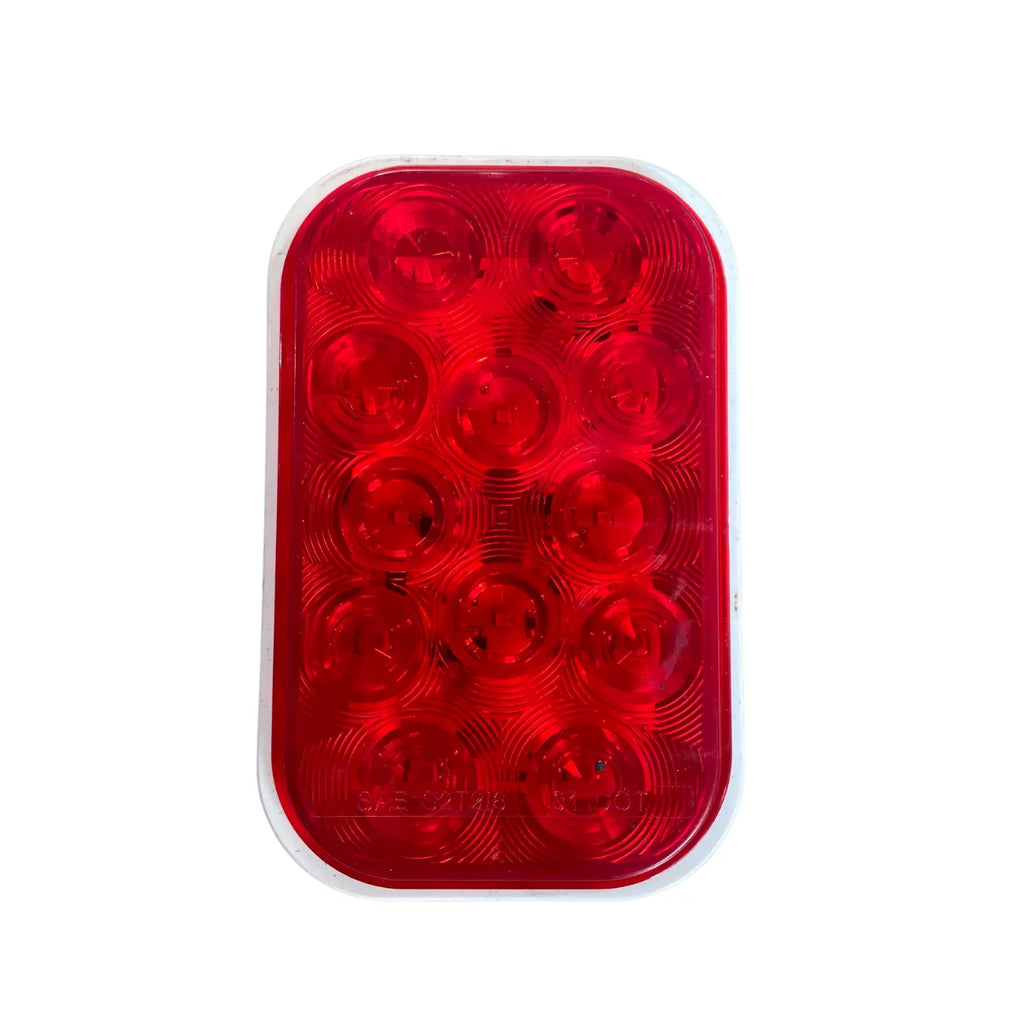 Optronics STL33RBK rectangular red LED stop/turn/tail light, front view of 12-diode lens marked SAE S2 T2 I6 DOT