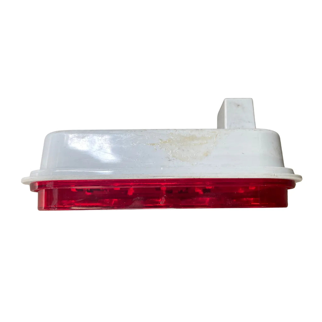 Side profile of Optronics STL33RBK LED stop/turn/tail light showing red lens, white housing and PL-3 plug housing