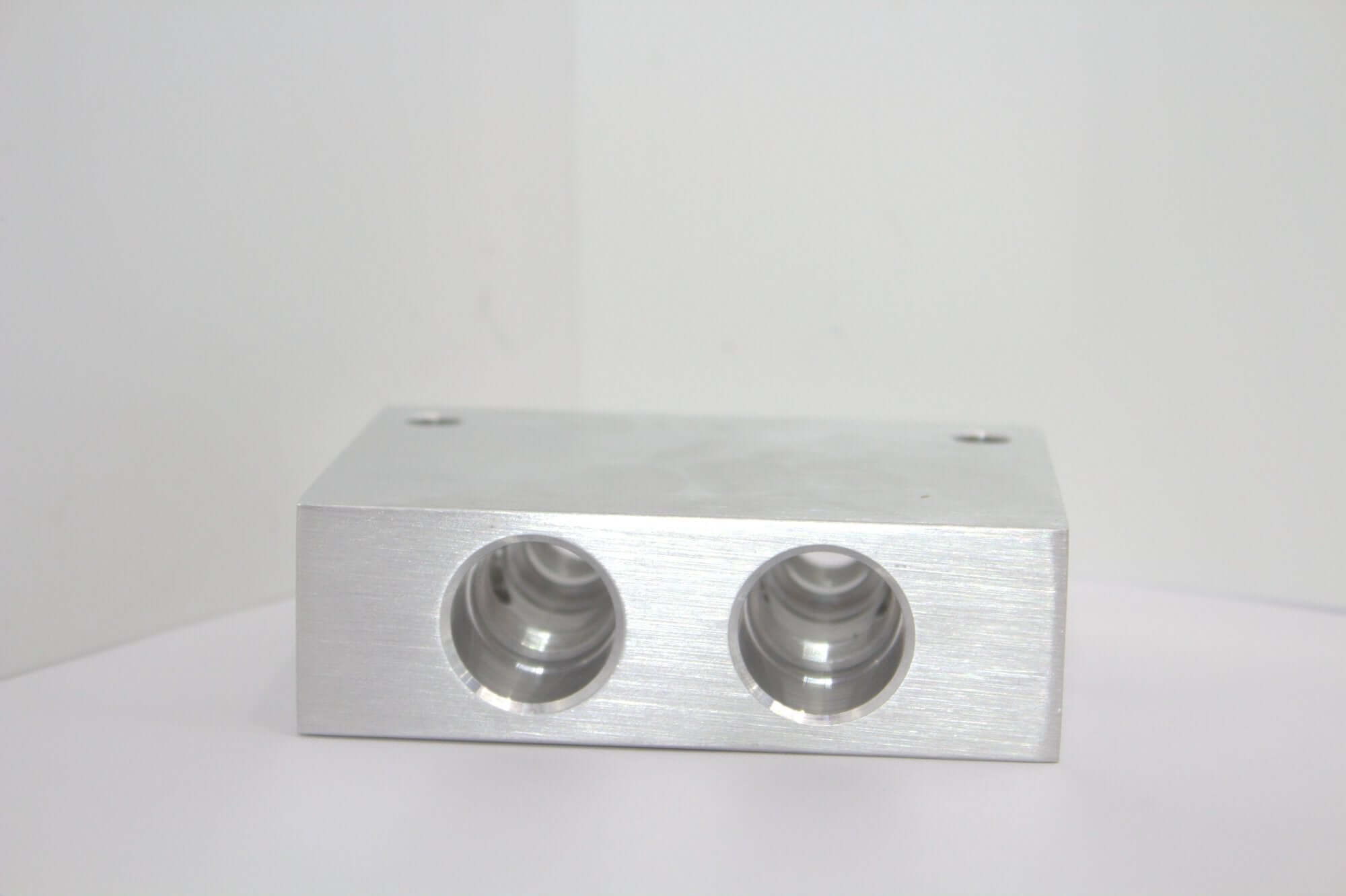 Aluminum safety block cross pilot manifold YEI for hydraulic systems with dual ports, ideal for wrecker repair parts.