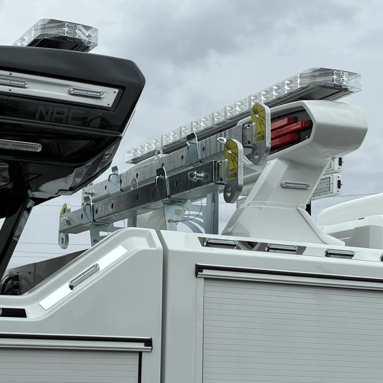 spreader bar holder with two spreader bars installed on tunnel box of NRC wrecker Truck