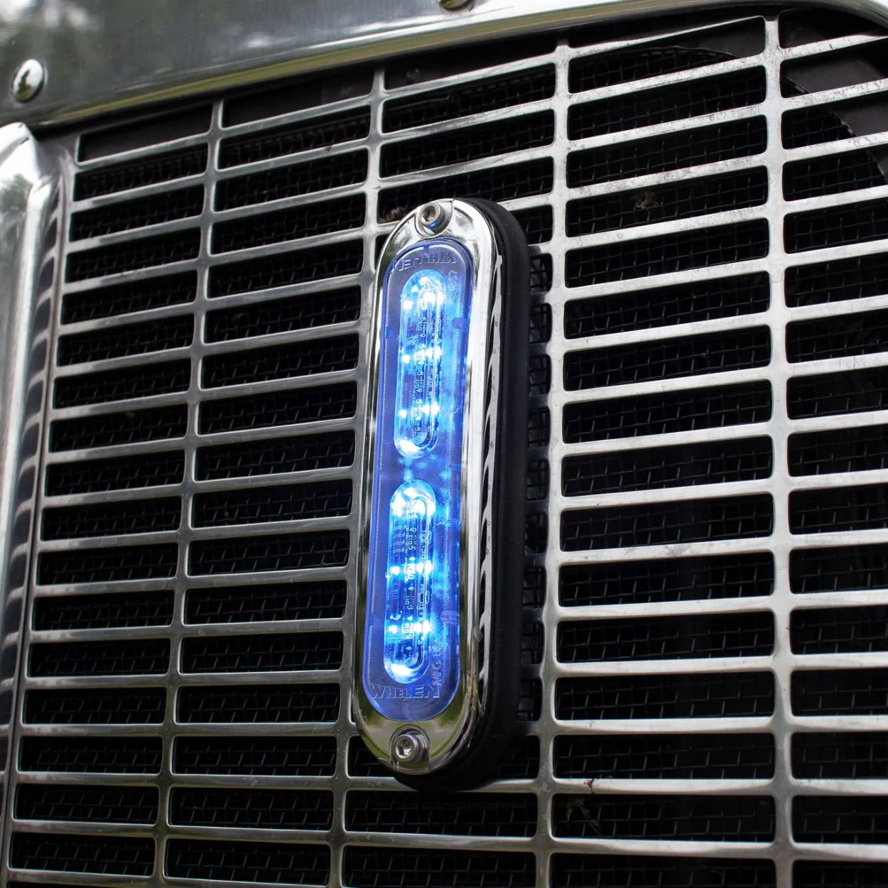 Whelen T-Series Ion Blue Strobe Light mounted on the grill of a tow truck