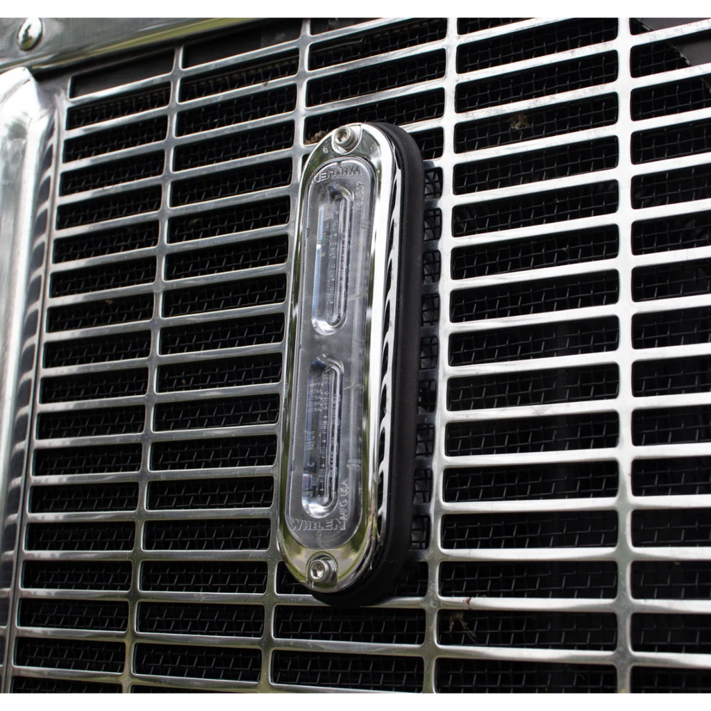 Whelen T-Series Ion Strobe Lights mounted on the grill of a semi truck