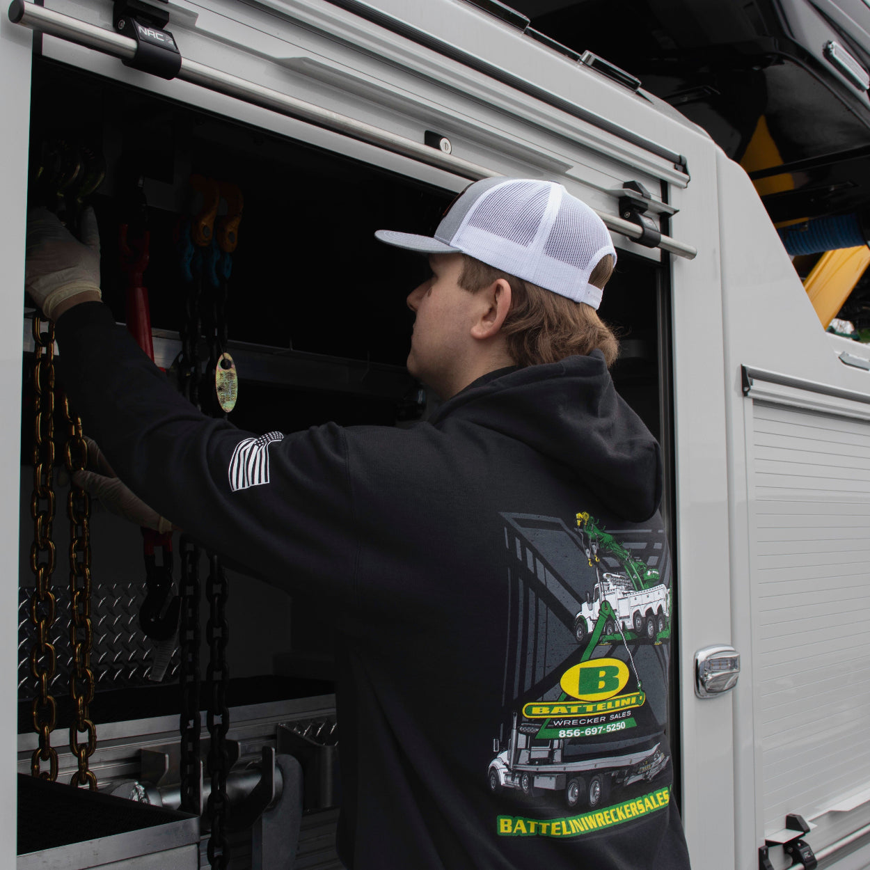 Working wearing the Battelini Trucking Hooded Sweatshirt