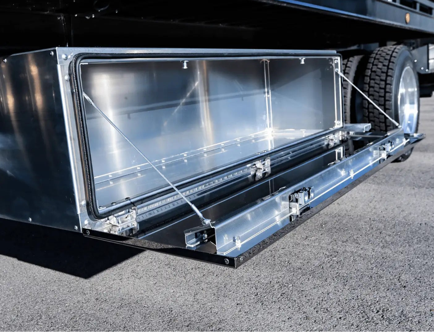a picture of a workman series underbody toolbox installed on a rollback tow truck